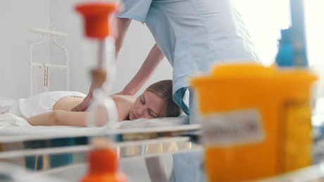 Physiotherapist massaging woman's back