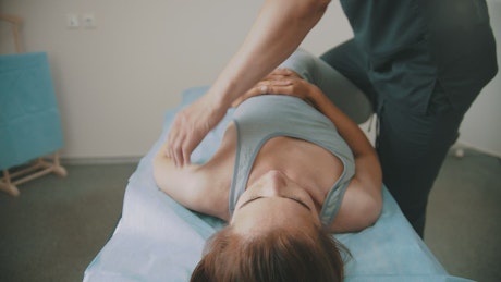 Physiotherapist working on a woman's body.