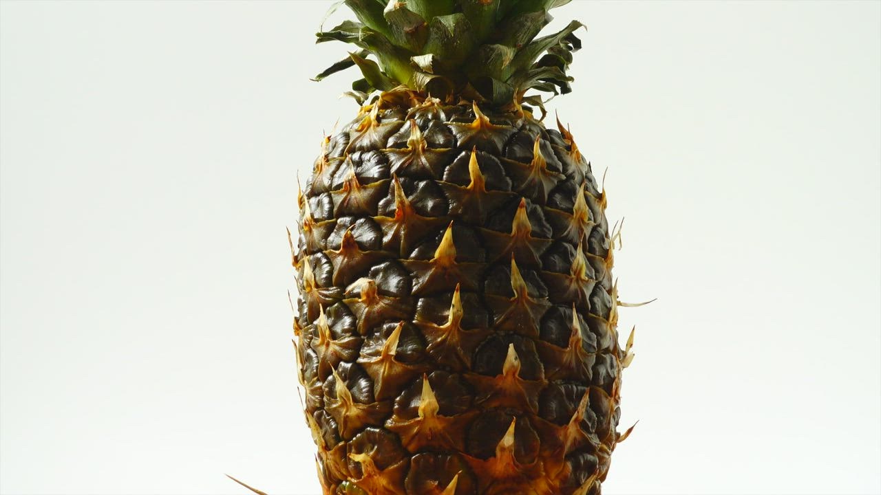 Pineapple spinning on a white background - Free Stock Video
