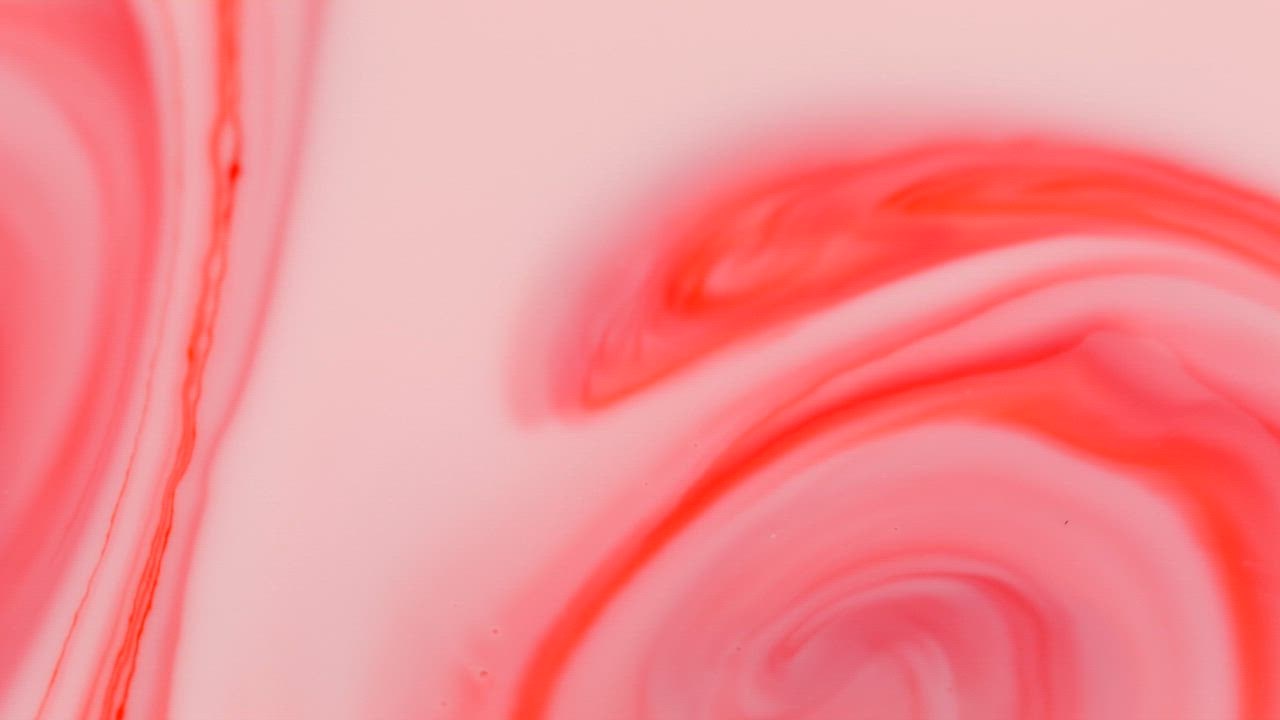 Pink ink in different shades in motion.