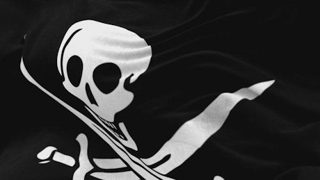 Pirate or hacker flag waving, close up.