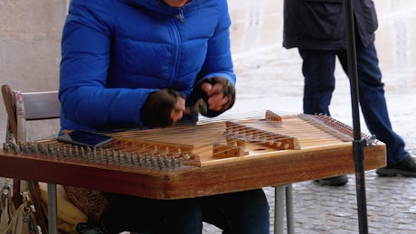 Playing a wooden xylophone on the street