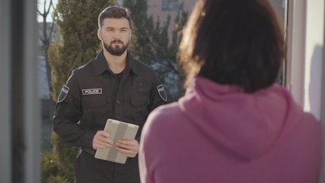 Police officer talking to a woman