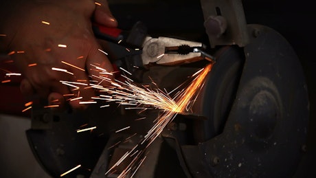 Polishing a metal on a machine.