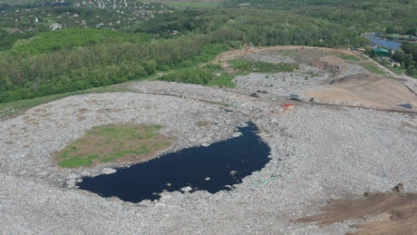 Polluted lake near a garbage landfill
