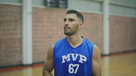 Portrait of a basketball player practicing shots.