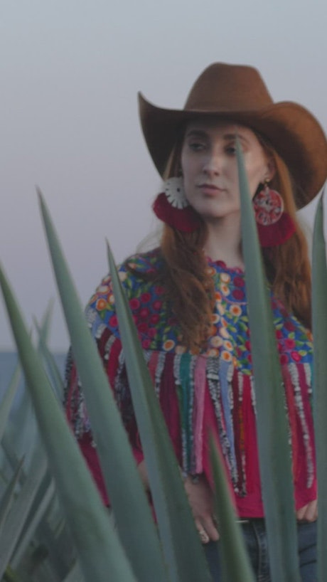 Portrait of a girl in Mexican attire among magueys.