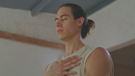 Portrait of a man breathing while meditating.
