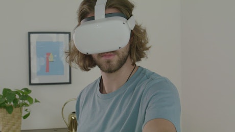 Portrait of a man playing with virtual reality glasses.