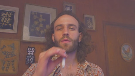 Portrait of a man smoking a cigarette.