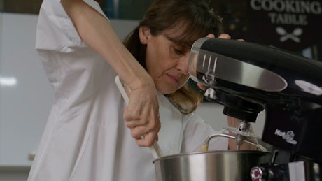 Portrait of a pastry chef preparing the mixture for a cake.