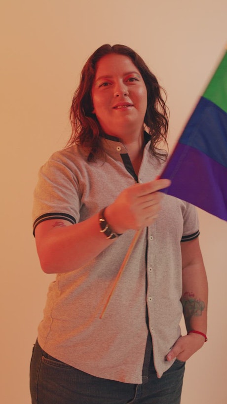 Portrait of a woman waving the LGBT flag