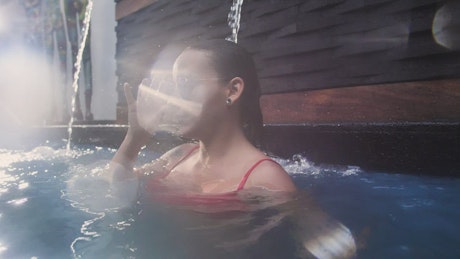 Portrait of a young woman in swimming pool.