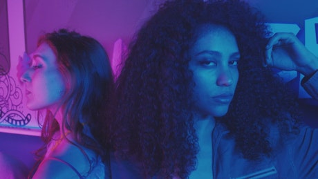 Portrait of two fashion girls in a nightclub.