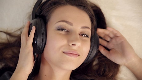 Portrait of woman enjoying while listening to music