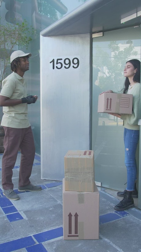 Postman delivering a package to a girl.
