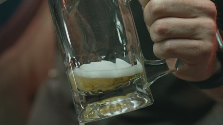 Pouring beer in a mug.