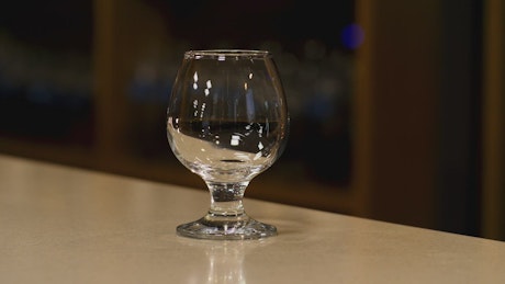 Pouring Cognac into a glass