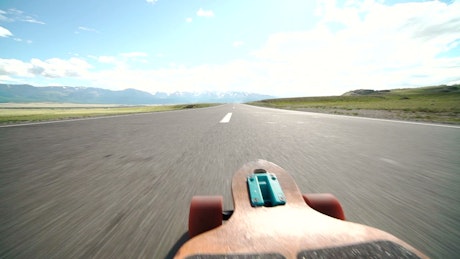 POV of a longboard on the road