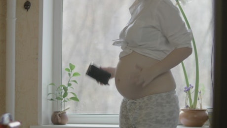 Pregnant woman dancing around.