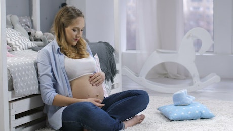 Pregnant woman talking to her child.