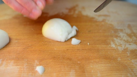 Preparing an onion for soup.