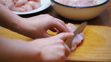 Preparing chicken meat in fillets.