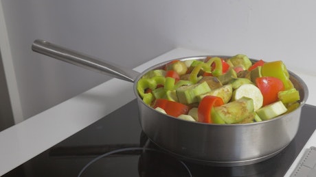 Preparing vegetables in a pan.
