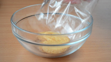 Putting cookies into a bowl.