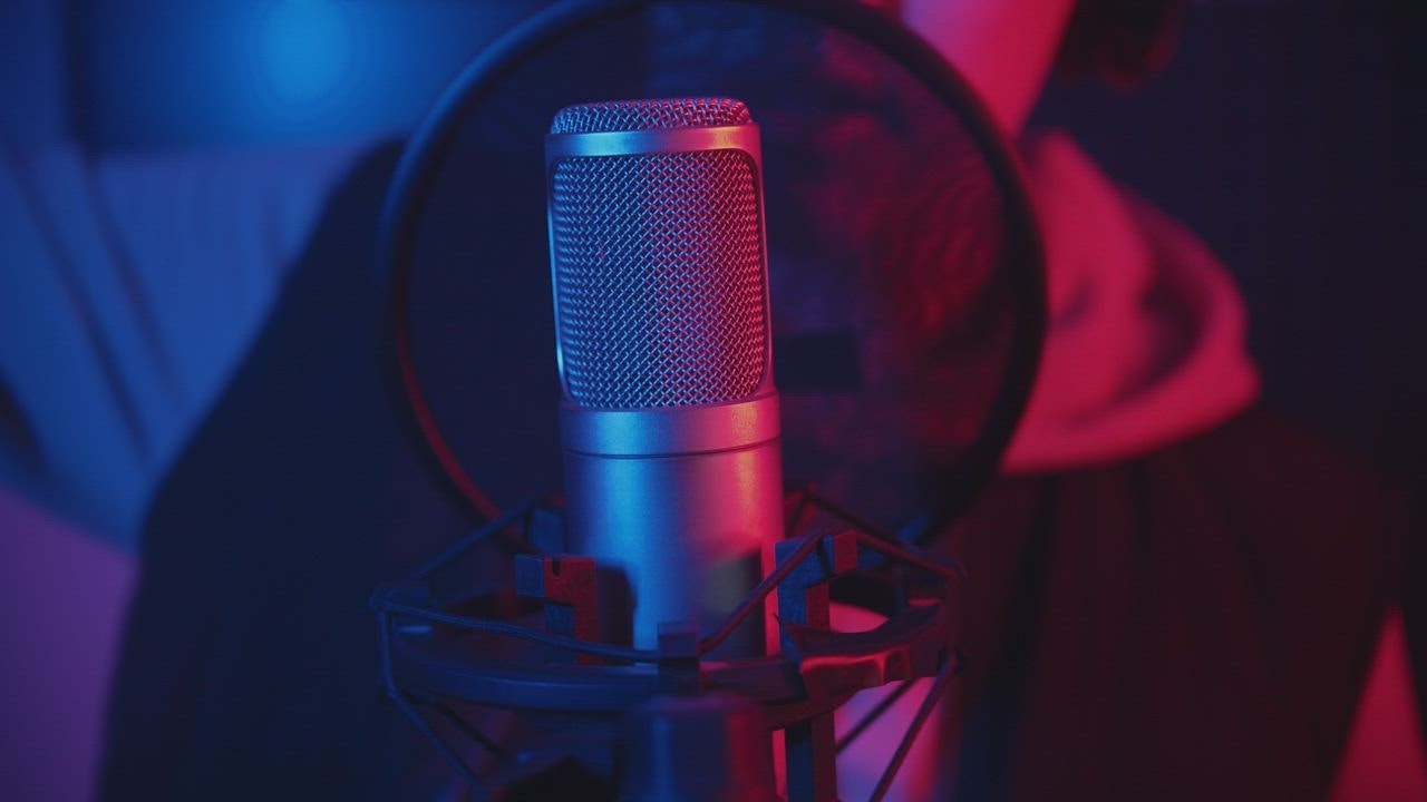 Rapper recording a track in a music studio - Free Stock Video