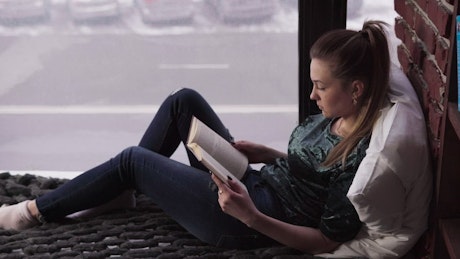 Reading a book in a city apartment