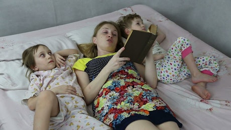 Reading a night time bed story to children.
