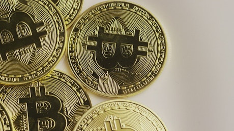Real bitcoin coins rotating on a surface