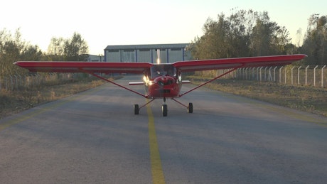 Red aircraft driving through the track