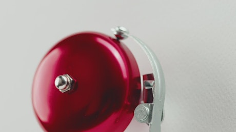 Red fire alarm bell hanging on the wall.