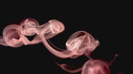 Red smoke moves across a black background.