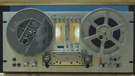 Retro audio tape recorder in motion.
