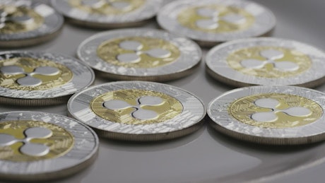 Ripple Bitcoins coins rotating on a surface.