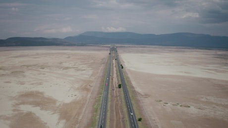 Road with traffic that divides a dry lagoon