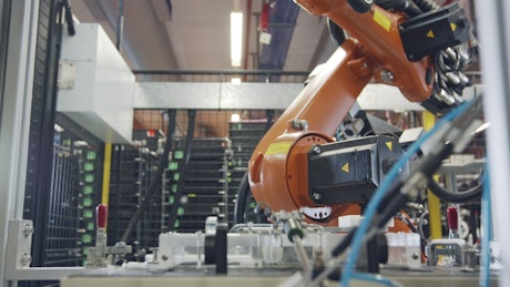 Robot working in an electronics manufacturing facility.