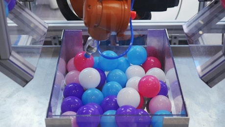 Robotic arm moving balls.