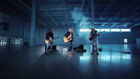 Rock band performing on a warehouse for video