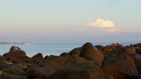Rocky seashore in front of the sea skyline.
