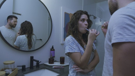 Romantic couple brushing their teeth together.