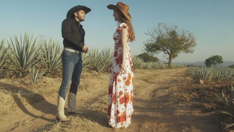 Romantic couple of ranchers in a maguey field