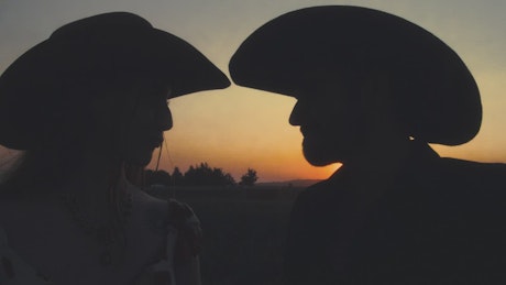 Romantic scene of a couple at sunset on a ranch.