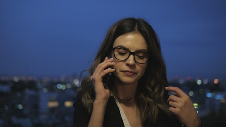 Rooftop phone call by businesswoman.