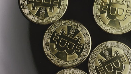 Rotating shot of golden bitcoins from above