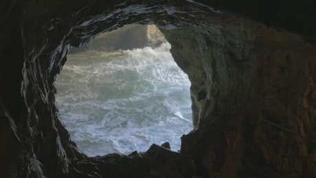 Rough sea under a cave