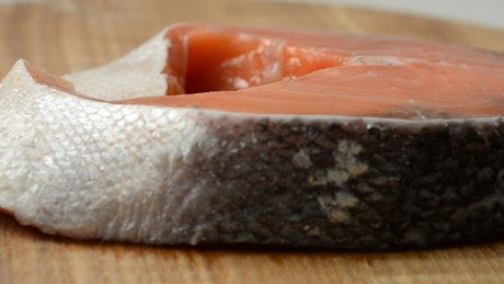Salmon steak with skin.